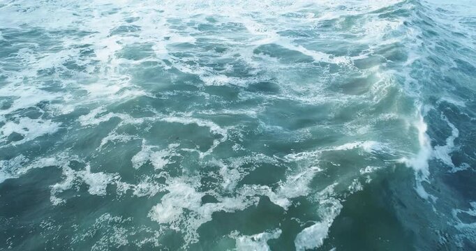Dramatic aerial view of a stormy sea with chaotic wave patterns