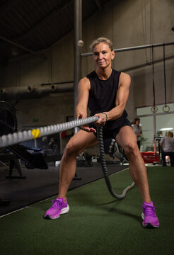 Fitness and health concept. A fit young woman works out in a modern gym. Athletic woman doing exercise.
