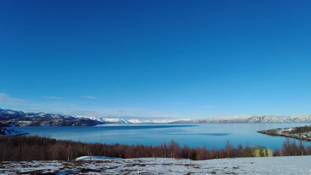 Altafjord with clear blue sky in winter Norwegian sea bay of fjord Alta panorama view footage