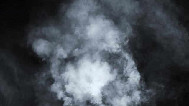 Abstract white smoke in slow motion. Smoke, Cloud of cold fog in light spot background. Light, white, fog, cloud, black background, 4k, ice smoke cloud. Floating fog.