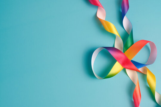 Autism acceptance month, Autism awareness day concept. Rainbow infinity - symbol of autism disorder, adhd, neurodiversity. Top view
