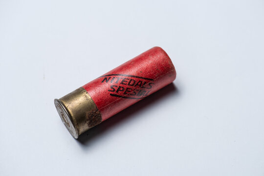Lindesnes, Norway - July 21 2019: Red shotgun shell with worn brass base.