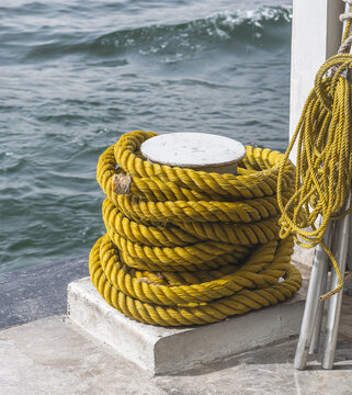Yellow ropes on a boat, mooring line 