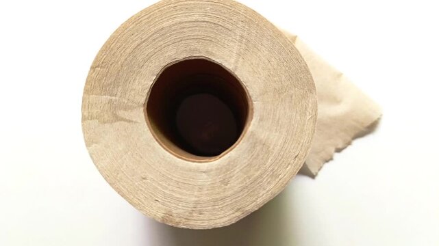 Brown recycled toilet paper roll isolated on white background with shadow