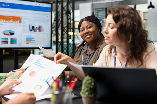 Female forecast affiliates showcase business ambition and execution, meeting to align vision with project goals and review finance reports on archived documents. Business organization.