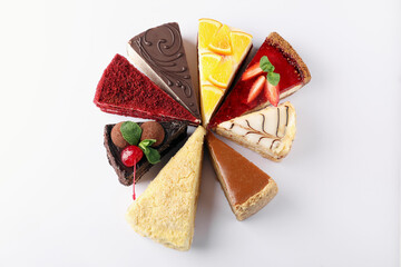 Fototapeta premium Pieces of different tasty cakes on white background, flat lay