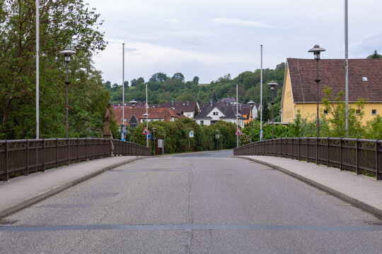 Road bridge leading into small town of Neudenau, Germany with houses and countryside