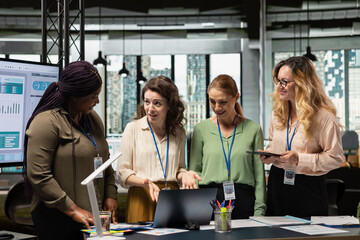 Career focused businesswomen reviewing analytics and aligning objectives, empowered by data and...