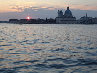 Fototapeta premium Sunset in Venice on water with Santa Maria della Salute in the background