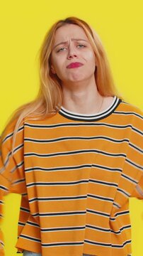 Upset frustrated annoyed Caucasian blonde woman in blouse raising hands in indignant expression, quarreling, asking reason of conflict, why such stubborn. Adult girl isolated on yellow background