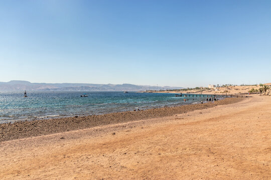 South Beach in Aqaba, Jordan. Egyptian coast near Taba in the beckground