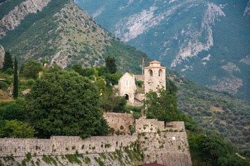 Fototapeta premium Guard tower and walls of Fortress Bar, in Stari Bar, Montenegro, with forested hills in the background