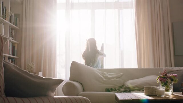 Morning, kid and running to open curtain for flare, sunshine and start day with reflection in home. Girl, child and window with drapes in living room with sunlight, thinking and back view with energy