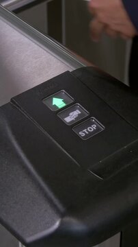 An automated gate's indicator changes from green to red as a card is presented for entry.