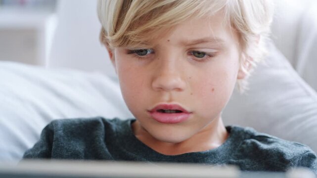 Couch, speaking or child with tablet for gaming, digital world or interactive site for online activity. Talking, entertainment platform or boy with battle for virtual contest, tech or play in home