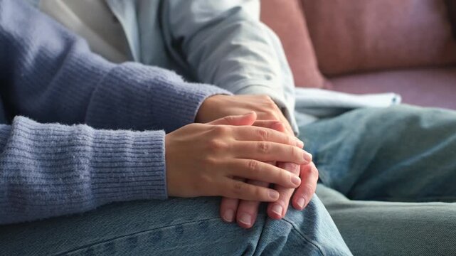 Close-up of a tender moment between two people as hands gently intertwine, showcasing connection, support, and loving care. Perfect for themes of relationships, comfort, and intimacy.
