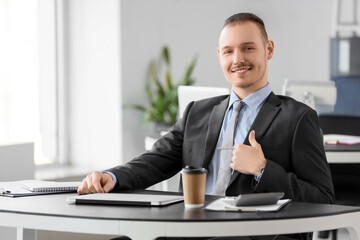 Fototapeta premium Handsome businessman sitting at desk in office