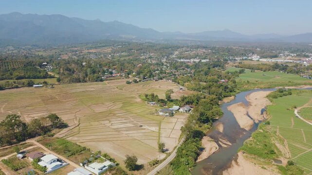 Aerial 4K of green countryside fields in the valley of Pai, Thailand