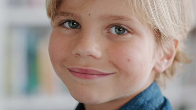 Education, face and smile of boy in classroom at school for development, future or growth. Knowledge, learning and study with happy kid student on campus for academics, curriculum or syllabus