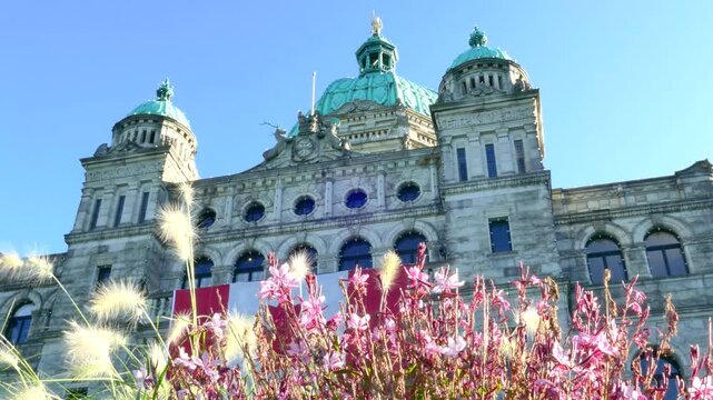 Victoria, British Columbia, Canada: March 25, 2026 - Canadian Flag and Flowers at BC Parliament Buildings Victoria