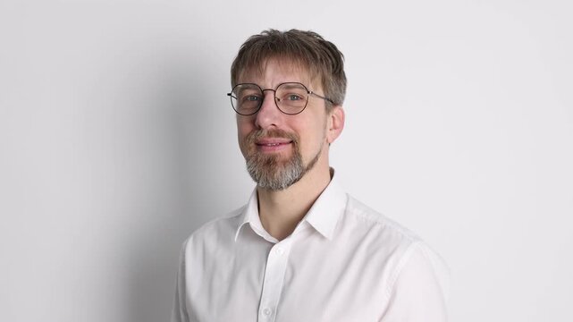 Handsome man in glasses posing on white background