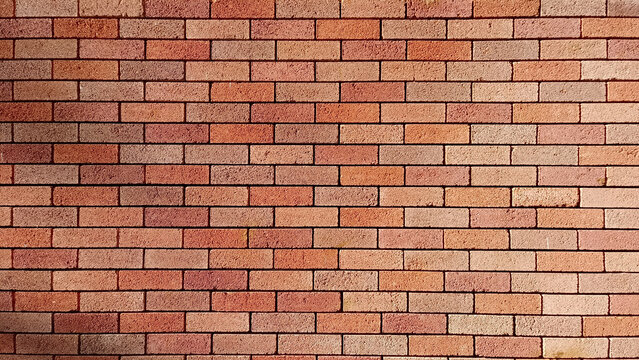 High-quality texture of a classic red brick wall. The masonry shows variations in red, brown, and tan colors with dark mortar lines. Ideal for architectural backgrounds, grunge designs, and patterns.