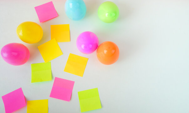 Colorful easter eggs with sticky notes on white background creative spring holiday planning concept with copy space.