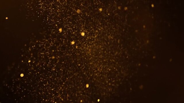 Golden sparks flying in darkness.