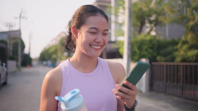 Young active woman drink whey protein shake bottle eating diet food using phone calorie AI plan app after workout health care asia people happy relax anti aging life weight loss public green park walk