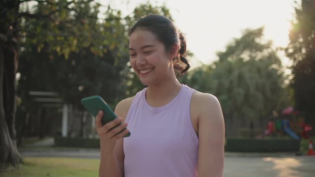 Young active woman drink whey protein shake bottle eating diet food using phone calorie AI plan app after workout health care asia people happy relax anti aging life weight loss public green park walk