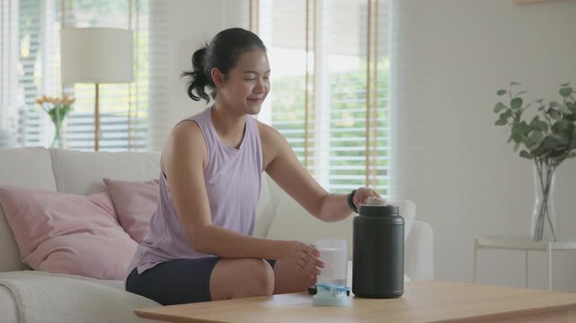 Young active Gen Z woman drink whey boost up protein shake bottle eating diet food calorie plan gain build muscle after workout. Health care asia people happy cheerful anti aging life weight loss.