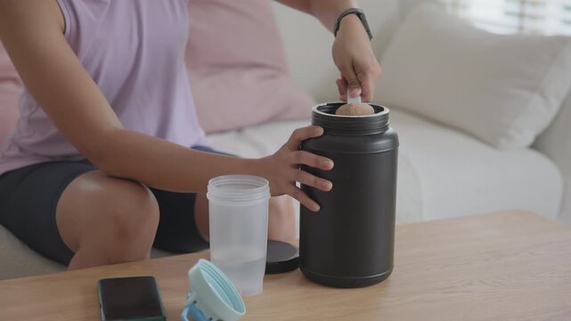 Young active Gen Z woman drink whey boost up protein shake bottle eating diet food calorie plan gain build muscle after workout. Health care asia people happy cheerful anti aging life weight loss.