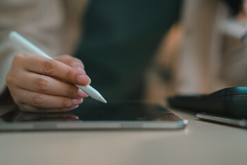 businesswoman using tablet with calculator on desk, representing digital finance, accounting, online banking, budgeting, tax management and modern fintech workflow in office