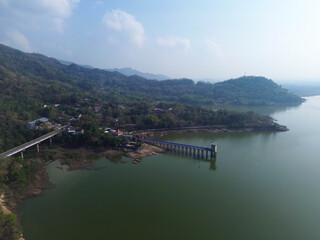 Fototapeta premium Aerial drone video of Gajah Mungkur Reservoir in Wonogiri, Indonesia. Scenic freshwater reservoir surrounded by green hills and rural landscape, serving as an important water resource for irrigation, 
