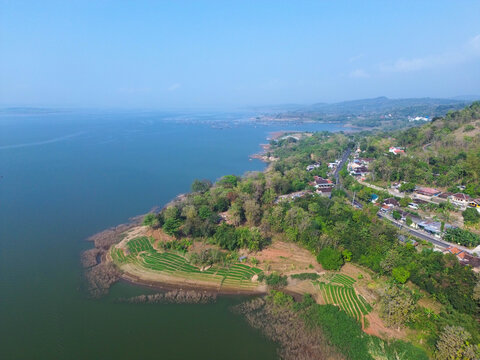 Aerial drone video of Gajah Mungkur Reservoir in Wonogiri, Indonesia. Scenic freshwater reservoir surrounded by green hills and rural landscape, serving as an important water resource for irrigation, 