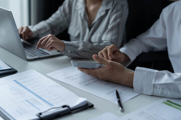 Fototapeta premium Businessman and businesswoman working together in an office