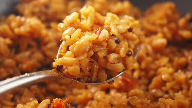 closeup of spoon pick bulgur rice 