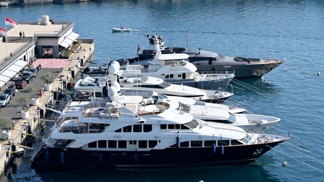Luxury yachts moored in port hercule monaco, showing elegant design and vibrant maritime activity