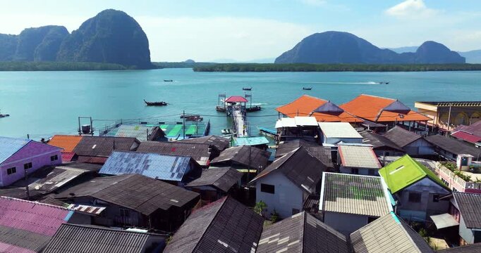 Flying Above Stilt Houses Toward Floating Football Field In Koh Panyee, Phang Nga Bay, Thailand. wide drone shot
