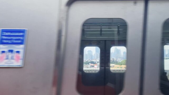 Fast Passing Commuter Line Train on Adjacent Track Seen from Inside a Moving Train to Jakarta Kota