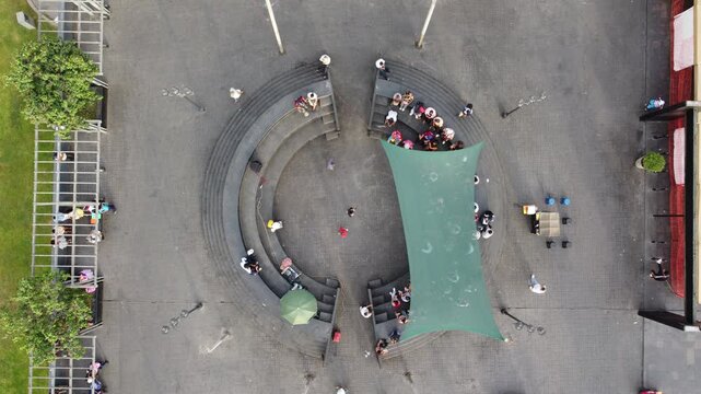 Aerial top down view of people in a public plaza amphitheater in lima