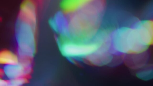 Blur prism. Holographic flare. Neon colorful luminosity on dark black background. Spectrum kaleidoscope sphere abstract bokeh effect.