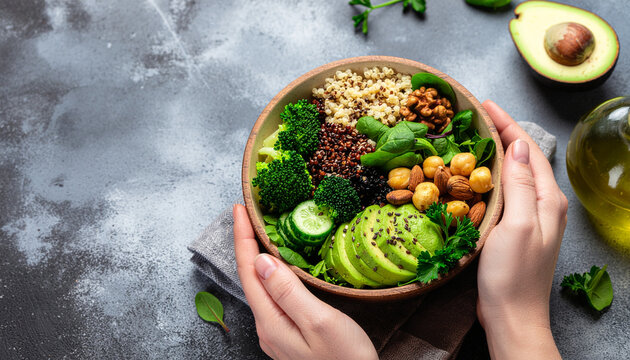 Healthy vegan bowl with avocado and fresh vegetables on textured surface