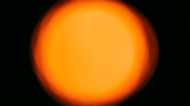 Blurred Orange Light Circle Glowing On A Dark Background With A Soft Warm Bokeh Effect