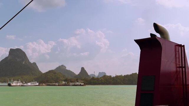 Ferry Superstructure With Vent Exhaust Framed Against Green Sea and Forested Hills Under Soft Sky, Industrial Travel And Coastal Navigation