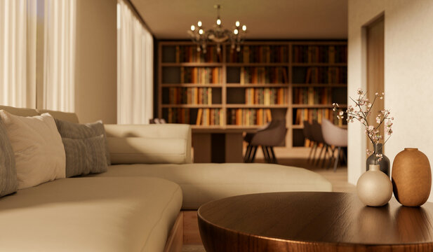 Sofa couch and round wooden table with chandelier hanging aside bookshelf and window in the library.
