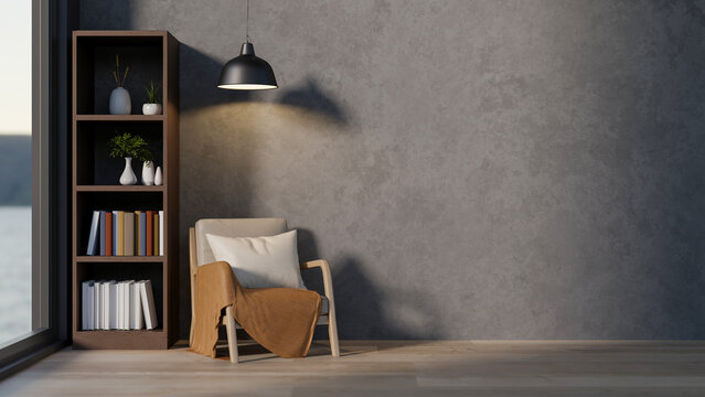 A wooden armchair under hanging lamp and bookshelf on parquet floor aside grey loft wall and window.