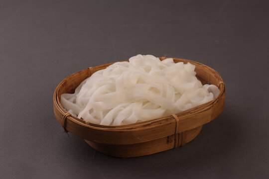 Kwetiau or kway teow or kuey teow noodles are flat, wide rice noodles made from rice flour and water, known for their smooth, slightly chewy texture and glossy appearance.