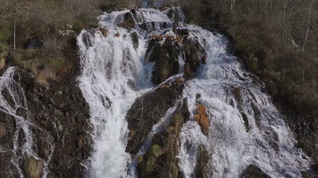 Powerful Waterfall Of The Furelos River On Rocky Cliffs In Toques, Galicia, Spain. Aerial Slow Motion Shot