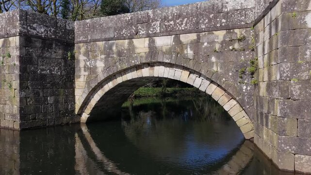 Stone Arches Bridge Of Brandomil Bridge (Ponte Romana de Brandomil) In Zas, Galicia, Spain. Aerial Pullback Shot